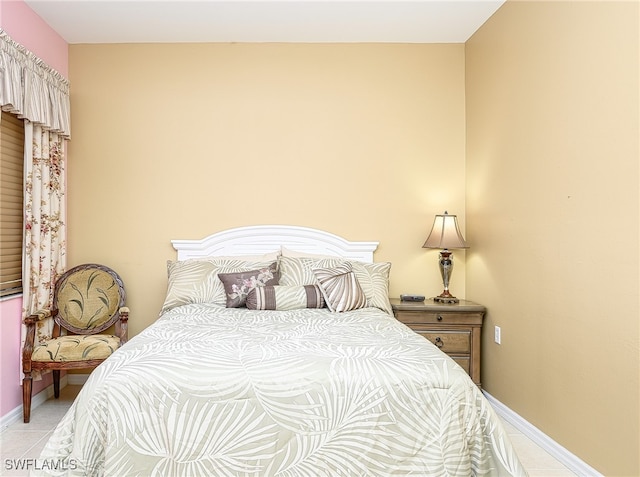 bedroom with light tile patterned floors