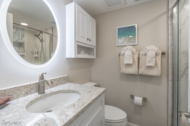 bathroom with vanity, toilet, and an enclosed shower