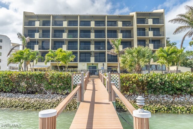 dock area with a balcony and a water view