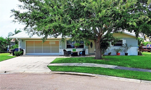 single story home with stucco siding, an attached garage, concrete driveway, and a front lawn