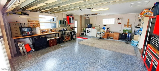 garage featuring a workshop area and washing machine and dryer