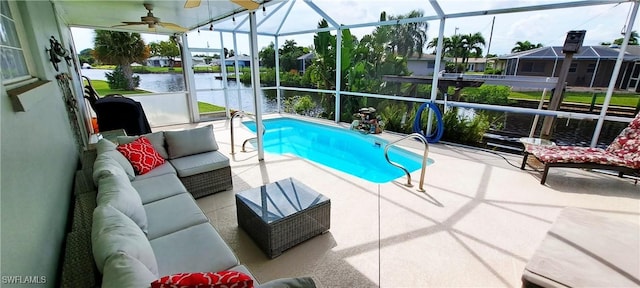 view of swimming pool with ceiling fan, a water view, a lanai, outdoor lounge area, and a patio