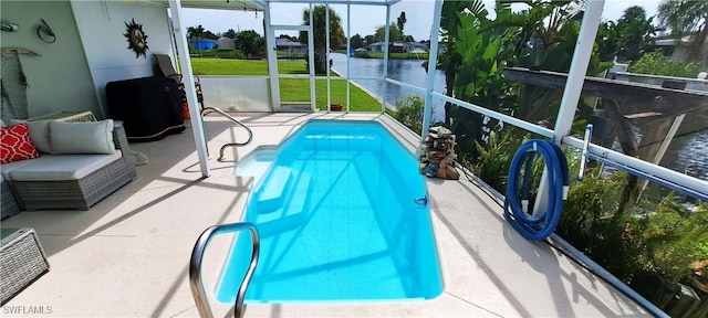 view of swimming pool featuring a water view, a lanai, and a patio area