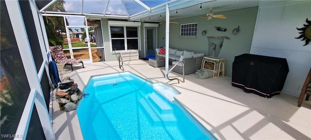 pool with a patio area, an outdoor living space, glass enclosure, and a ceiling fan