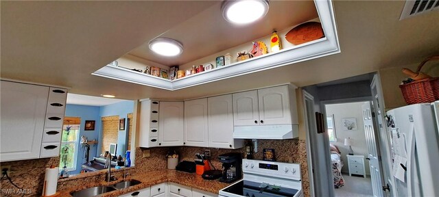 kitchen with white cabinetry, sink, white appliances, and decorative backsplash