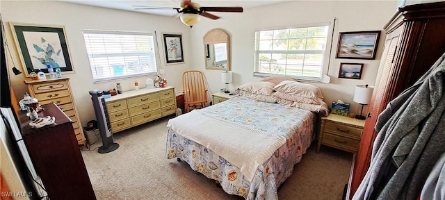 bedroom featuring multiple windows, carpet flooring, and ceiling fan