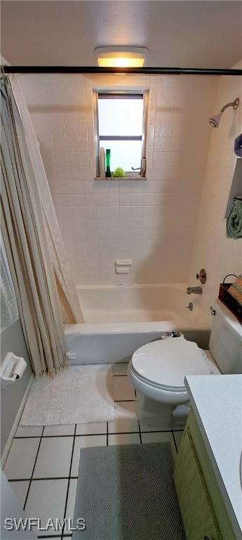 full bathroom with tile patterned flooring, vanity, shower / tub combo with curtain, and toilet