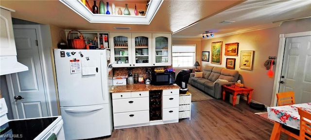 kitchen with glass insert cabinets, white appliances, dark wood-type flooring, and white cabinets