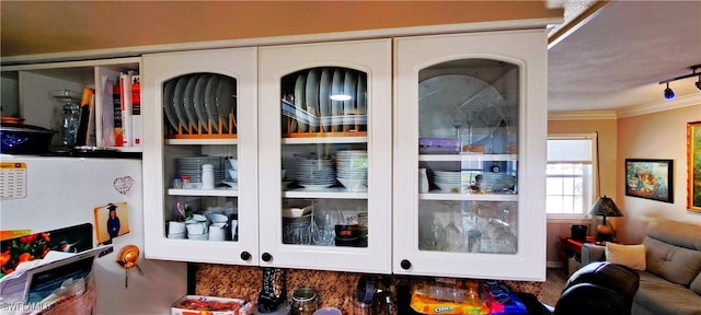 interior details featuring white cabinetry and ornamental molding