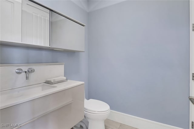 bathroom featuring vanity, toilet, and tile patterned floors