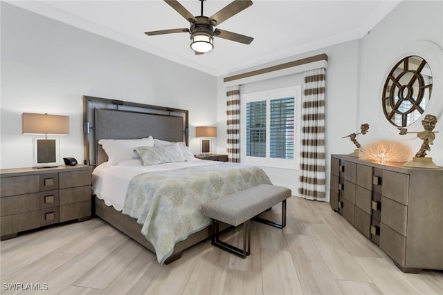 bedroom featuring ornamental molding, light wood-type flooring, and ceiling fan