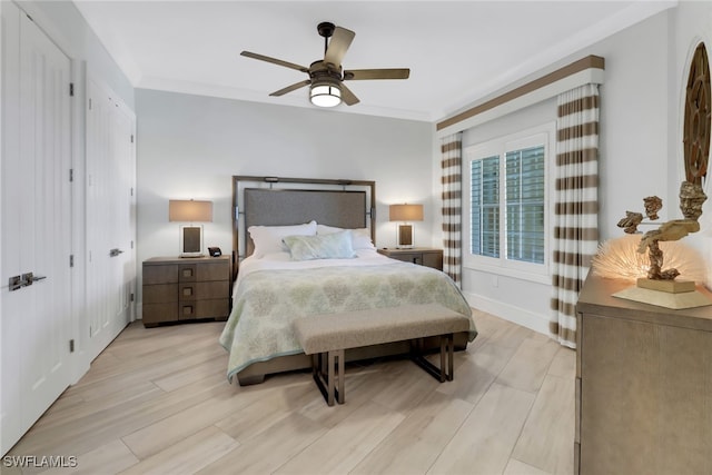 bedroom featuring ceiling fan, ornamental molding, and light wood-type flooring