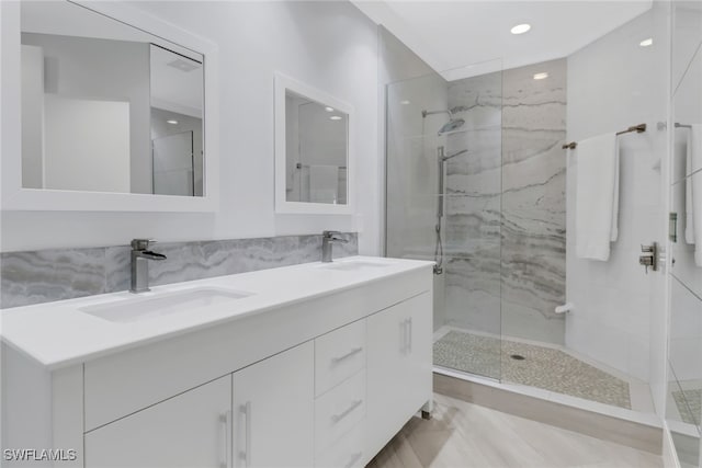 bathroom featuring vanity, a shower with shower door, and tile patterned floors