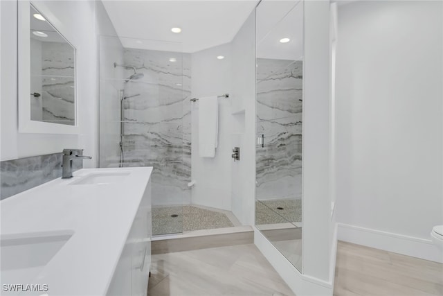 bathroom featuring vanity, toilet, hardwood / wood-style flooring, and a shower with shower door