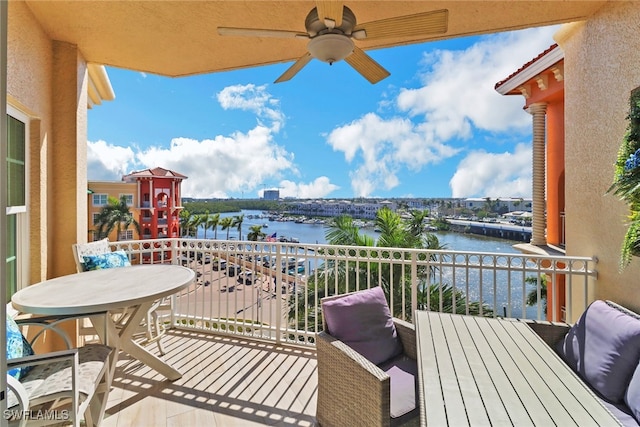 balcony with a water view and ceiling fan