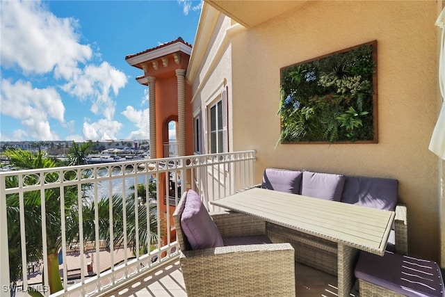 balcony featuring an outdoor hangout area and a water view