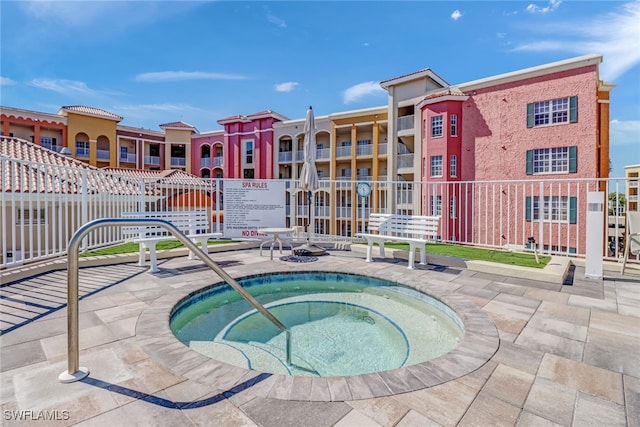 view of swimming pool with a patio and a community hot tub