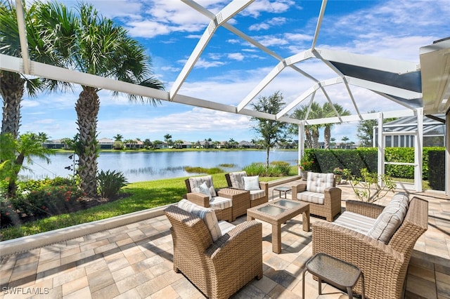 view of patio / terrace featuring an outdoor hangout area, glass enclosure, and a water view