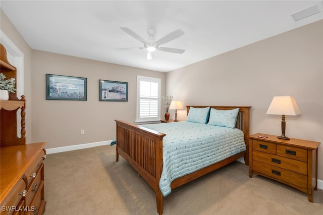 bedroom with light carpet, a ceiling fan, visible vents, and baseboards