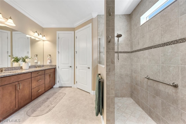 full bath featuring double vanity, ornamental molding, walk in shower, and a sink