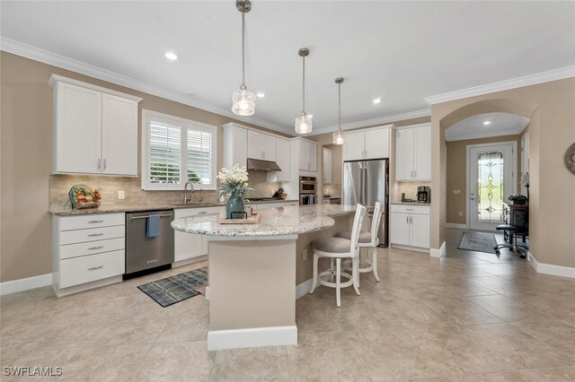 kitchen featuring appliances with stainless steel finishes, a kitchen island, and white cabinets