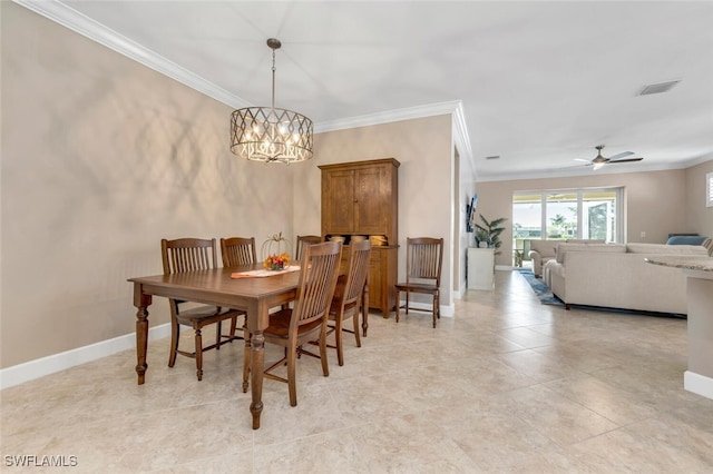 dining room featuring ornamental molding, visible vents, and baseboards