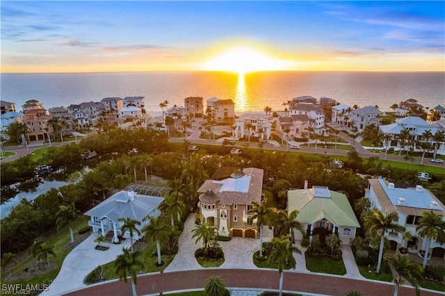 aerial view at dusk with a water view