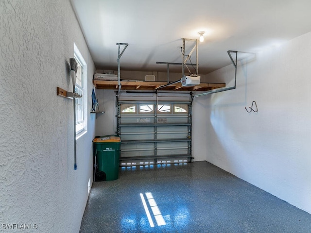 1105 Gayer Way Unit A-202, Marco Island, FL 34145 - garage featuring a textured wall and a garage door opener