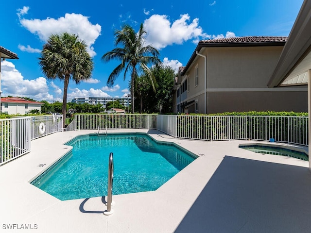 view of pool featuring a hot tub and a patio area