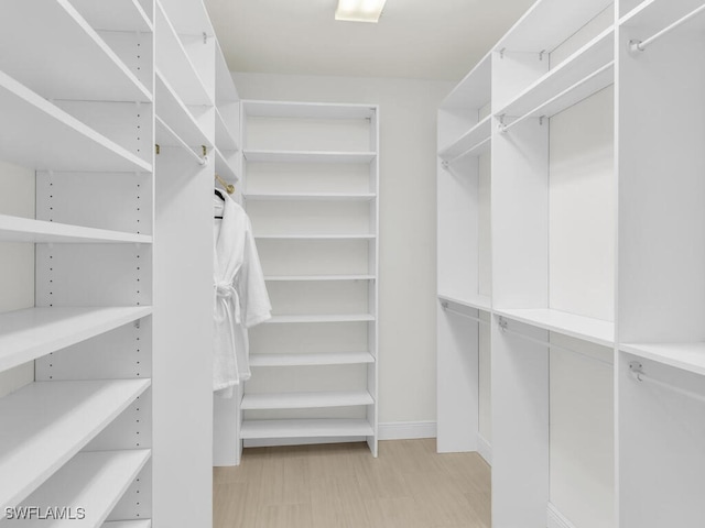 walk in closet featuring light wood-type flooring