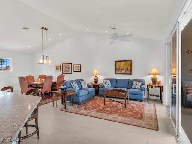 living room with ceiling fan and vaulted ceiling