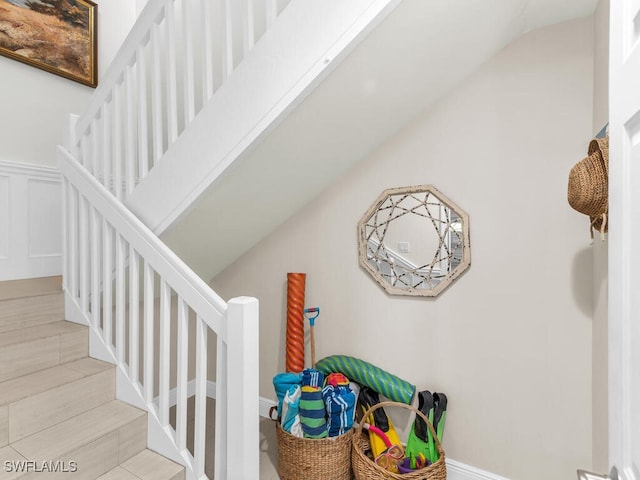 1105 Gayer Way Unit A-202, Marco Island, FL 34145 - staircase with lofted ceiling and a decorative wall