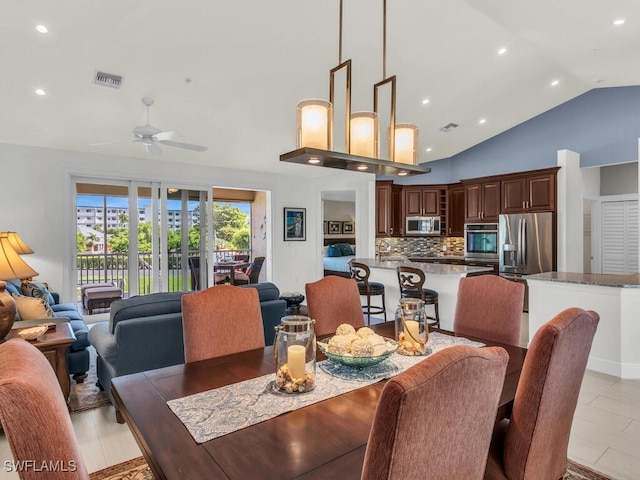 dining space with ceiling fan and vaulted ceiling