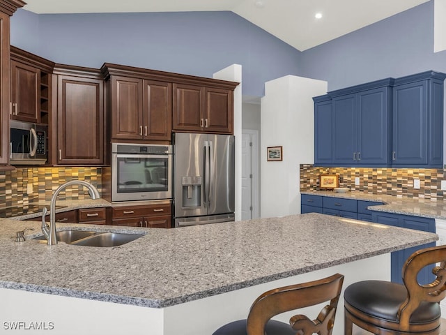 kitchen featuring dark brown cabinets, tasteful backsplash, sink, vaulted ceiling, and stainless steel appliances