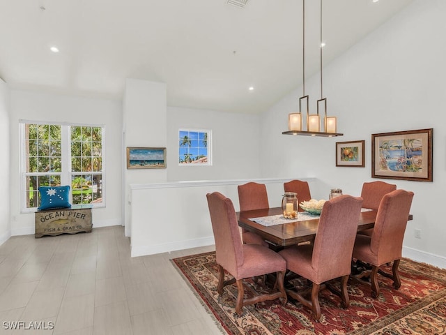 dining space with vaulted ceiling