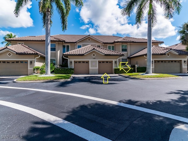 1105 Gayer Way Unit A-202, Marco Island, FL 34145 - mediterranean / spanish house with stucco siding, a tiled roof, and an attached garage