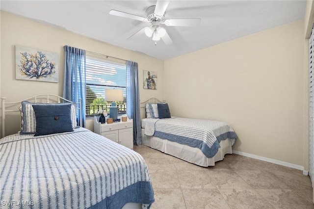 tiled bedroom featuring ceiling fan