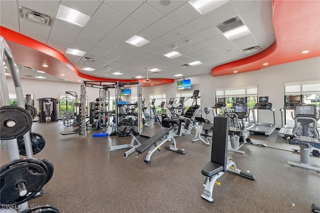 gym with a paneled ceiling