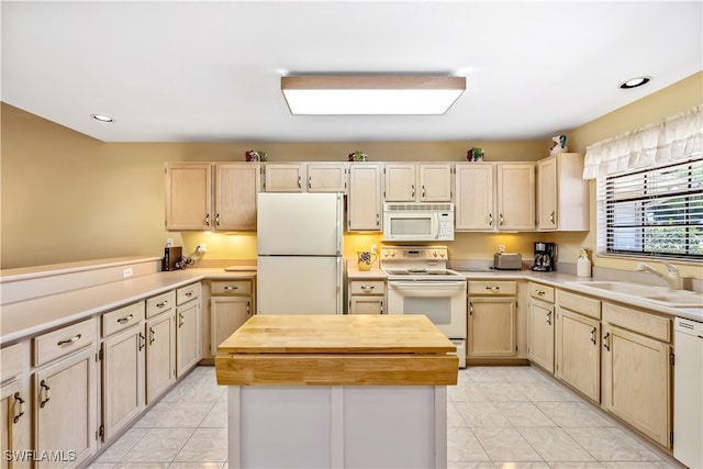 kitchen with a center island, wood counters, sink, white appliances, and light brown cabinetry