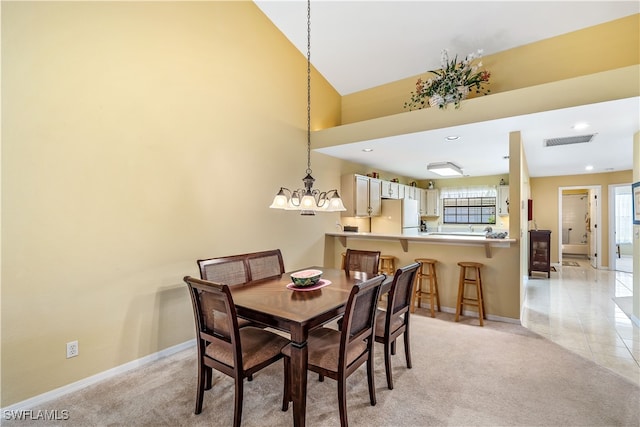 carpeted dining room with a chandelier