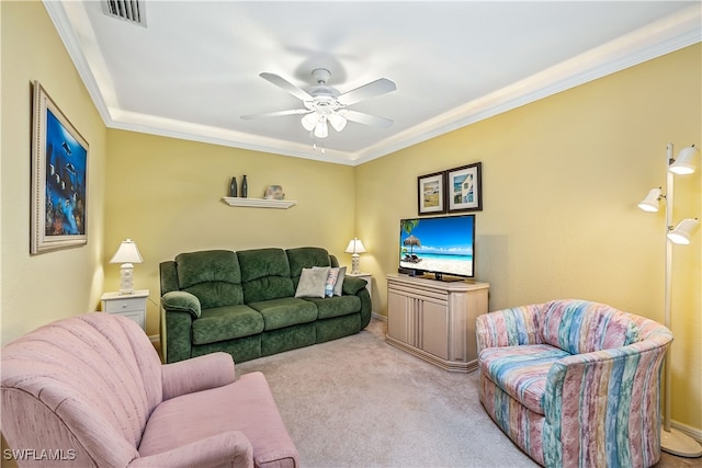 living room with ornamental molding, ceiling fan, and light carpet