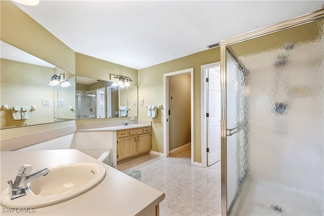 bathroom with walk in shower, tile patterned flooring, and vanity