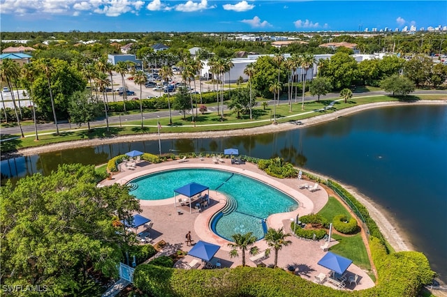 view of swimming pool featuring a water view and a patio area