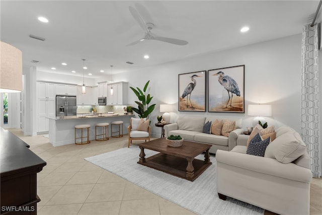 tiled living room with ceiling fan