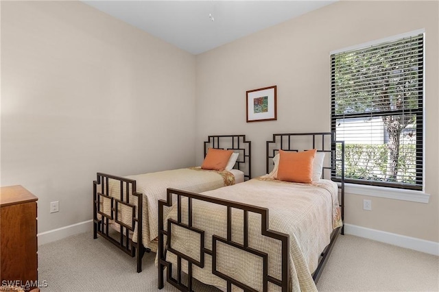 carpeted bedroom featuring baseboards