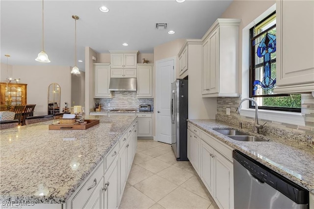 kitchen with light tile patterned floors, visible vents, a sink, under cabinet range hood, and appliances with stainless steel finishes