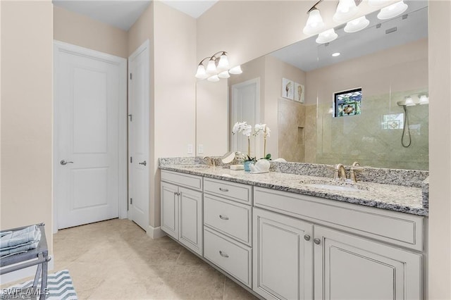 full bathroom featuring a sink, a notable chandelier, walk in shower, and double vanity