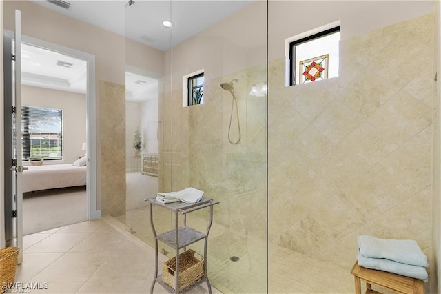 ensuite bathroom featuring walk in shower, connected bathroom, a healthy amount of sunlight, and tile patterned floors