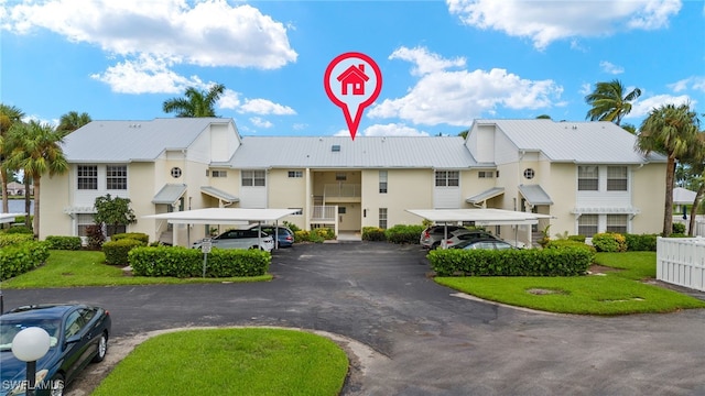 14987 Rivers Edge Ct Unit 139, Fort Myers, FL 33908 - view of building exterior with covered and uncovered parking and a residential view