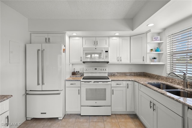 14987 Rivers Edge Ct Unit 139, Fort Myers, FL 33908 - kitchen with white appliances, a sink, white cabinets, open shelves, and a textured ceiling